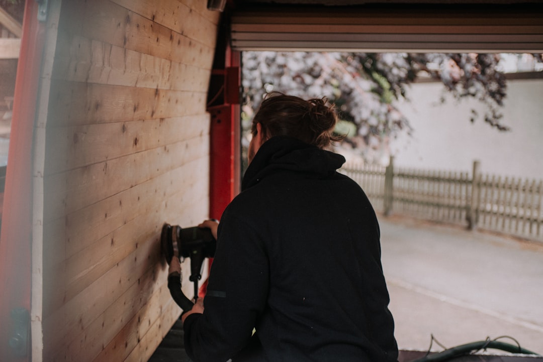 Professional technician repairing a residential garage door